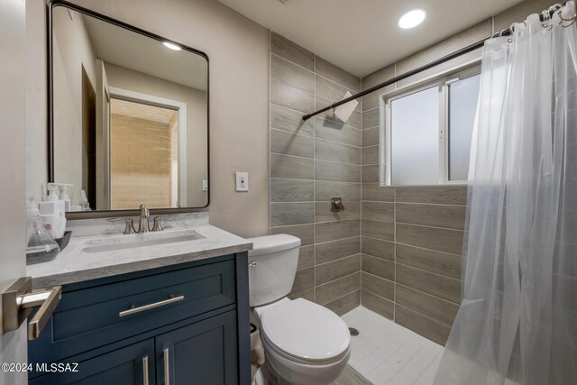 bathroom with toilet, curtained shower, and vanity