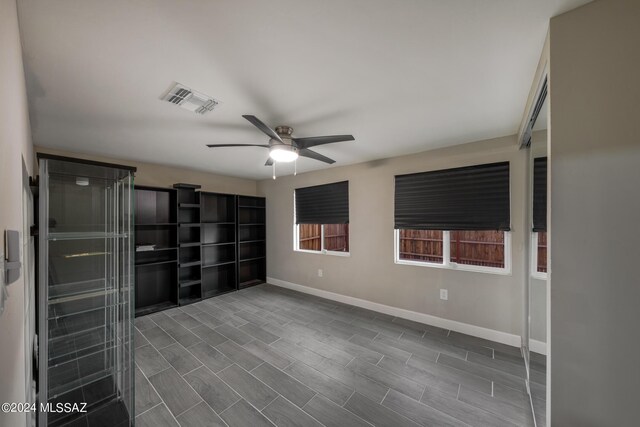 unfurnished room with ceiling fan and dark hardwood / wood-style flooring