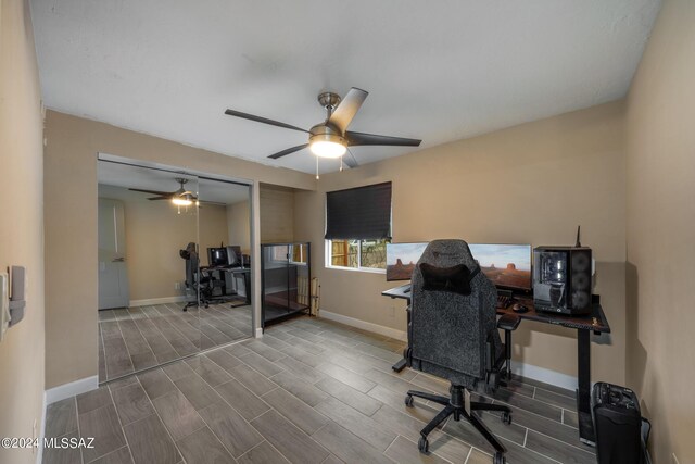 office area with ceiling fan and dark hardwood / wood-style floors