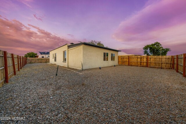 view of back house at dusk