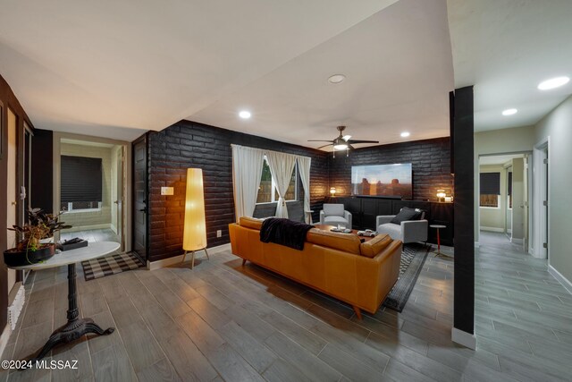 living room with ceiling fan and hardwood / wood-style floors