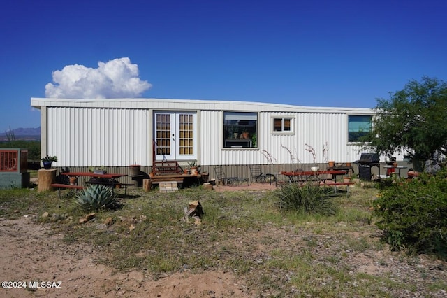 rear view of house featuring french doors