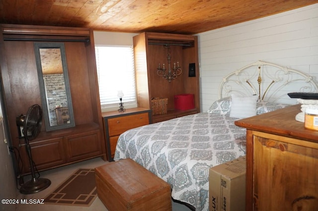 bedroom with wooden ceiling and wood walls