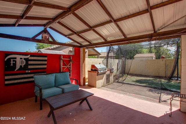 view of patio featuring a fenced backyard, a grill, and an outdoor kitchen