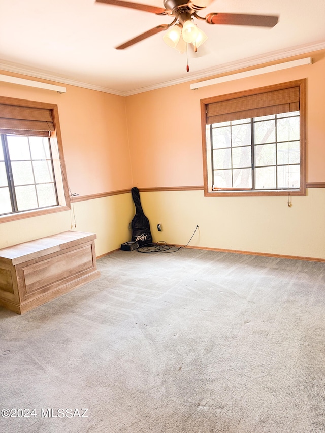 unfurnished room featuring ornamental molding, carpet flooring, and ceiling fan