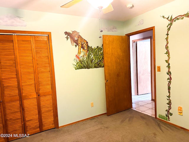 unfurnished bedroom with ceiling fan, a closet, and light colored carpet