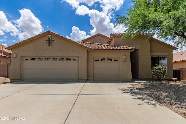 mediterranean / spanish home with a garage