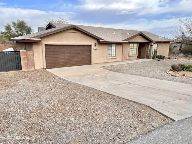 single story home featuring a garage, concrete driveway, a shingled roof, and stucco siding