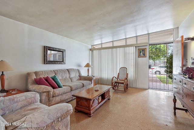 living room with light floors and floor to ceiling windows