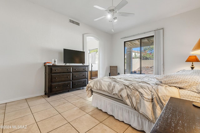 tiled bedroom with ceiling fan, access to outside, and multiple windows