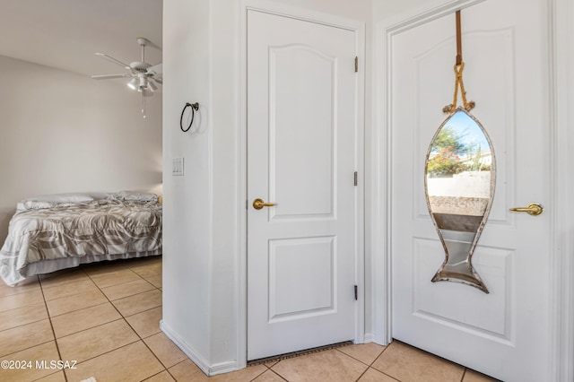 bedroom featuring light tile patterned floors and ceiling fan