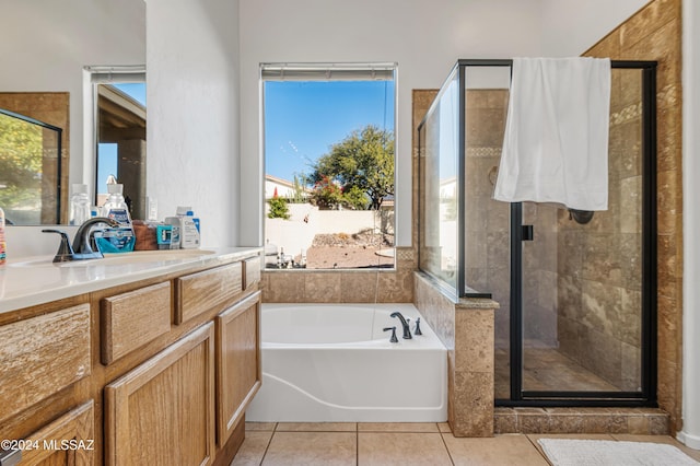 bathroom with plus walk in shower, vanity, and tile patterned floors