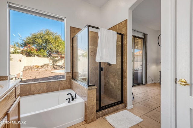 bathroom with tile patterned flooring, vanity, and plus walk in shower