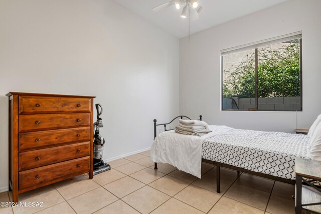 tiled bedroom featuring ceiling fan and lofted ceiling