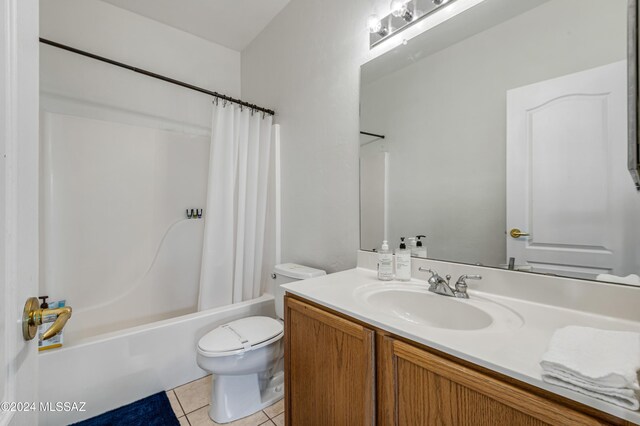 full bathroom with toilet, vanity, tile patterned floors, and shower / bathtub combination with curtain