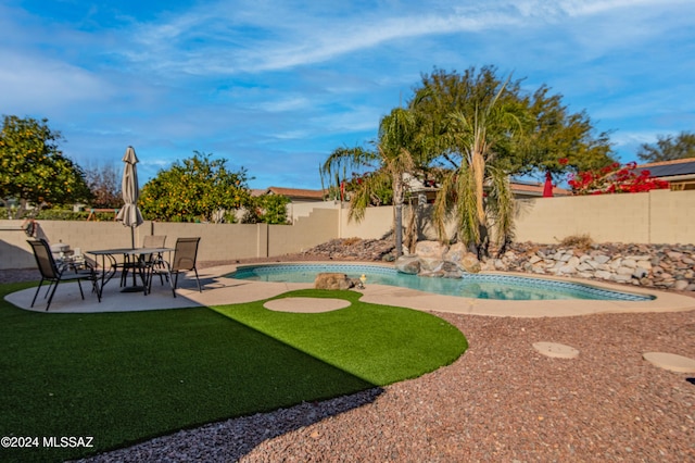 view of swimming pool with a lawn and a patio