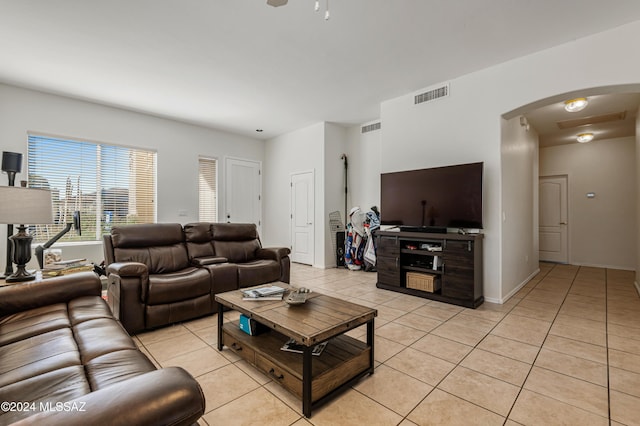 tiled living room with ceiling fan