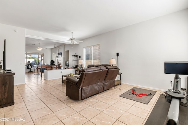 living room featuring light tile patterned floors and ceiling fan