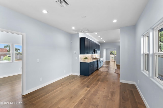 kitchen with decorative backsplash, stainless steel appliances, and dark wood-type flooring