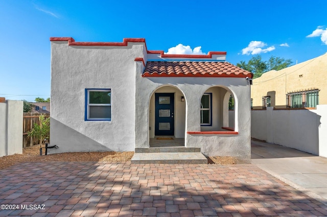 mediterranean / spanish house with covered porch