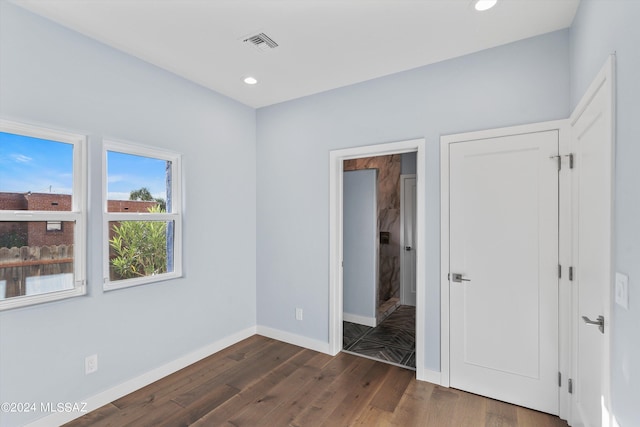 unfurnished bedroom featuring dark hardwood / wood-style floors