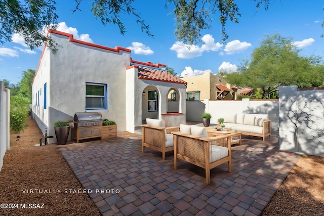 view of patio with area for grilling and an outdoor living space