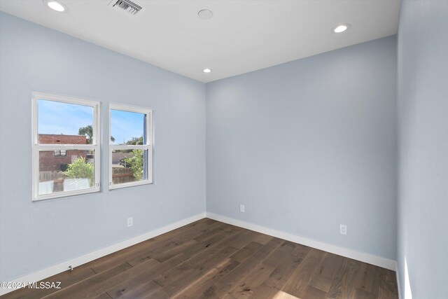 empty room featuring dark wood-type flooring