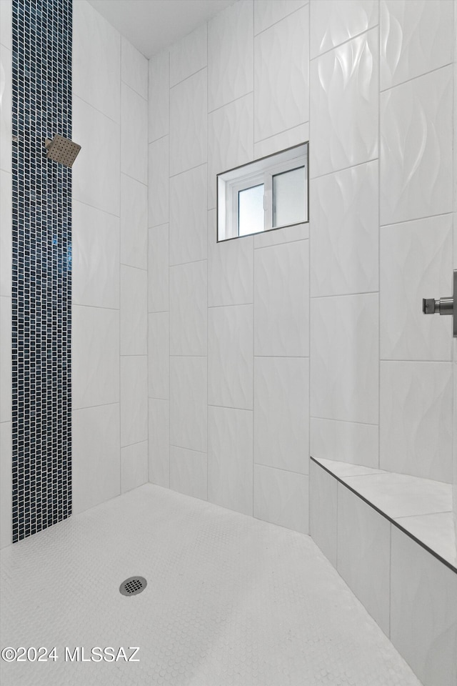 bathroom with a tile shower