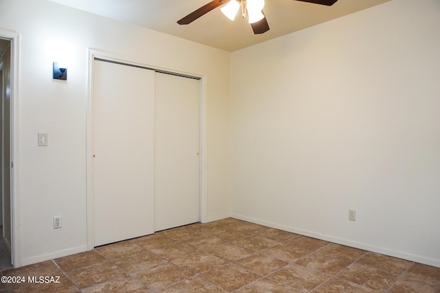 unfurnished bedroom with a closet, baseboards, and ceiling fan