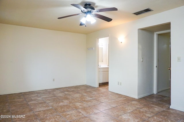 unfurnished room featuring visible vents, baseboards, and a ceiling fan