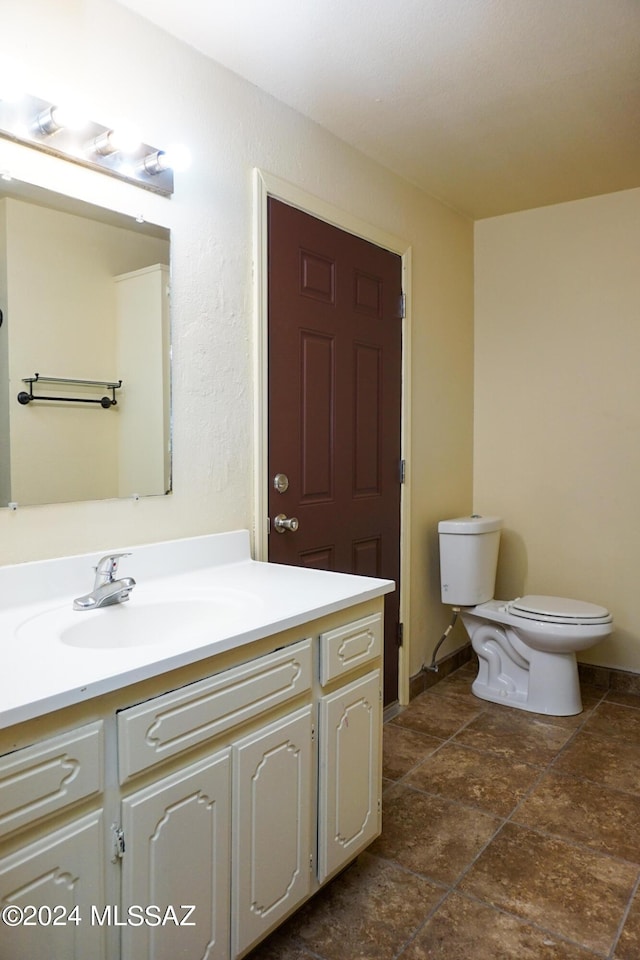 bathroom with toilet and vanity