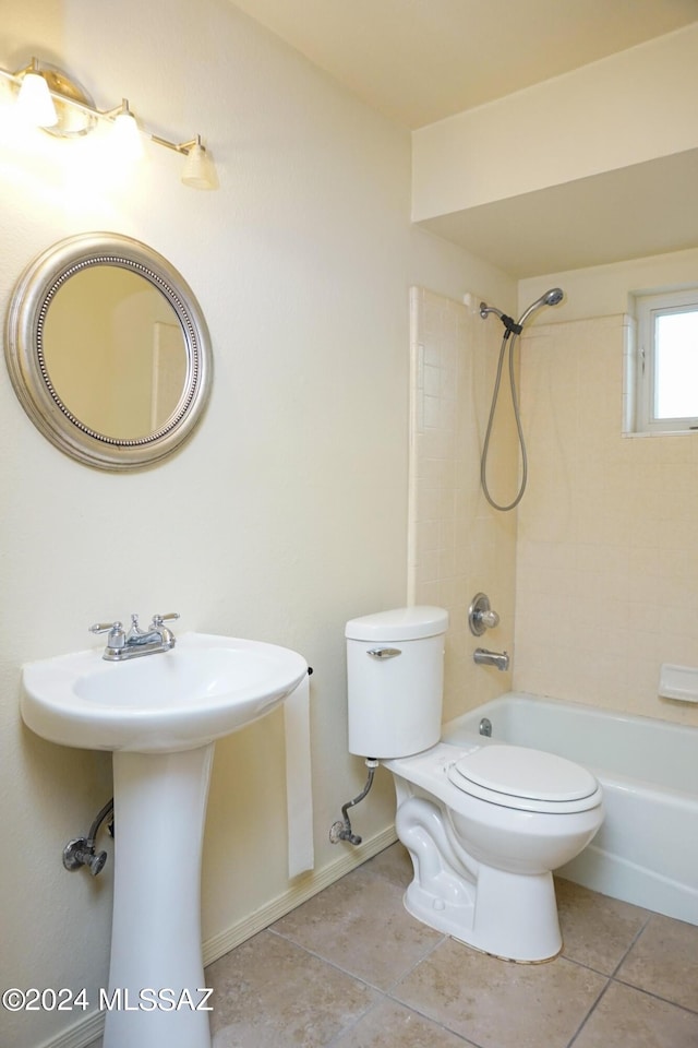 full bathroom with tile patterned floors, toilet,  shower combination, and a sink