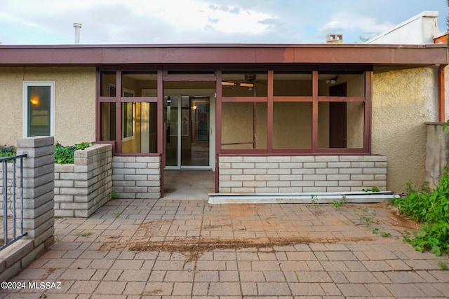 back of house featuring stucco siding and a patio