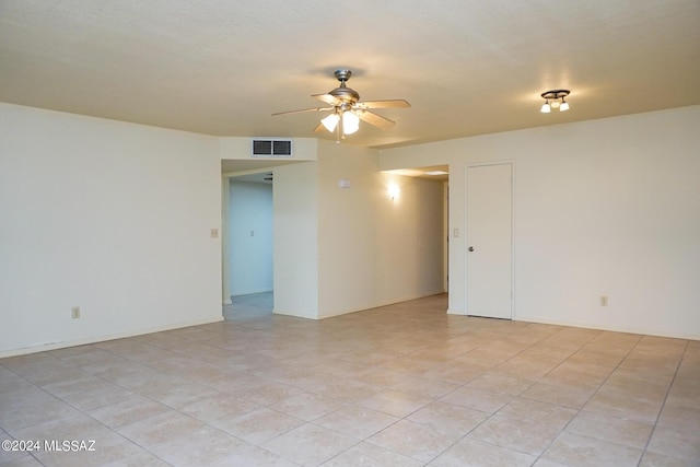 spare room with visible vents and ceiling fan