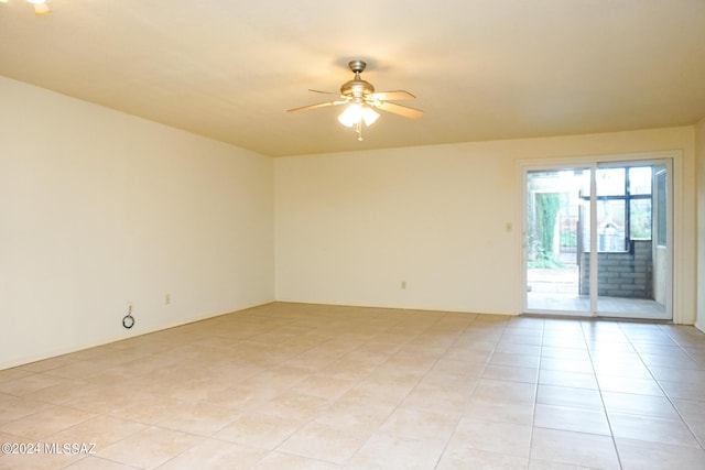 unfurnished room featuring light tile patterned floors and ceiling fan