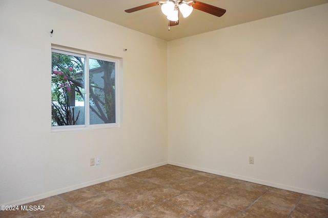 spare room with baseboards and ceiling fan