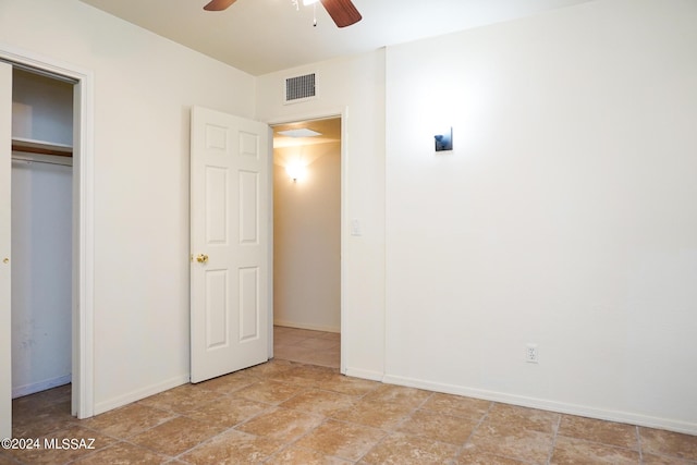 unfurnished bedroom featuring a closet, visible vents, a ceiling fan, and baseboards