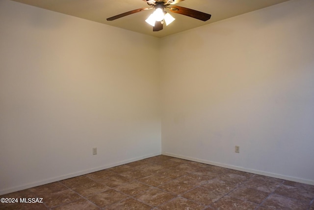 empty room featuring baseboards and ceiling fan