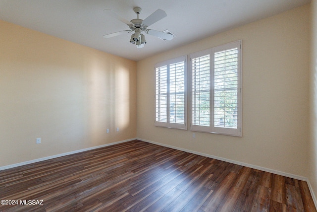 empty room with ceiling fan and dark wood-type flooring