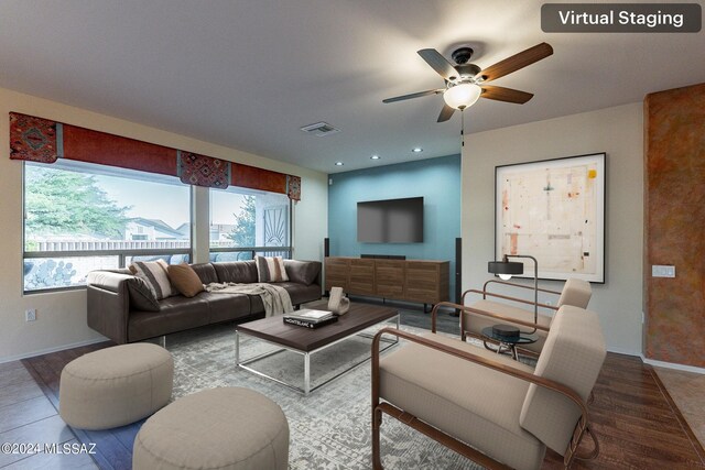 living room featuring wood-type flooring, ceiling fan, and plenty of natural light