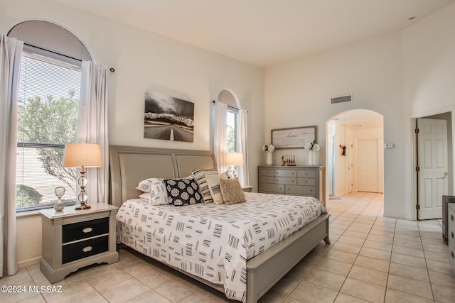 tiled bedroom featuring multiple windows