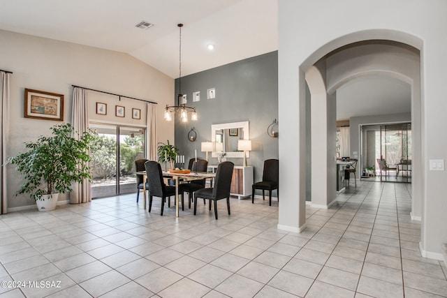 tiled dining space with vaulted ceiling