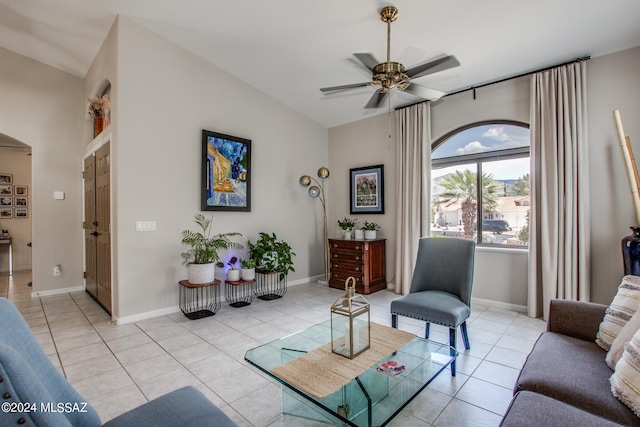 tiled living room with lofted ceiling and ceiling fan