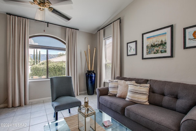 tiled living room featuring ceiling fan and lofted ceiling