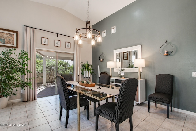 dining space featuring an inviting chandelier, light tile patterned flooring, and high vaulted ceiling