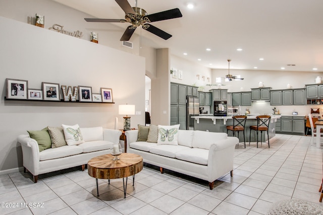 tiled living room featuring a towering ceiling and ceiling fan