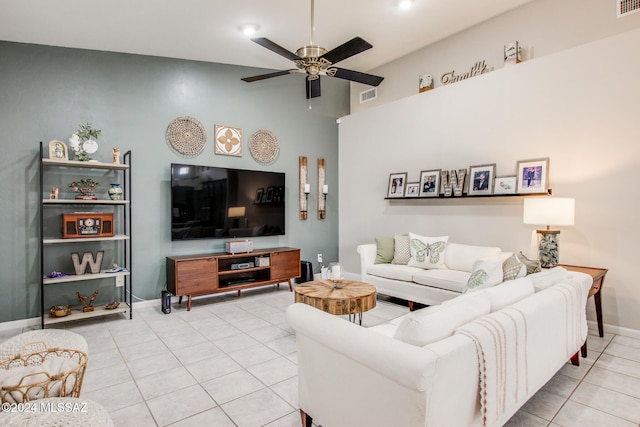 tiled living room featuring ceiling fan and a towering ceiling