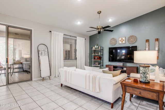 tiled living room featuring ceiling fan and vaulted ceiling