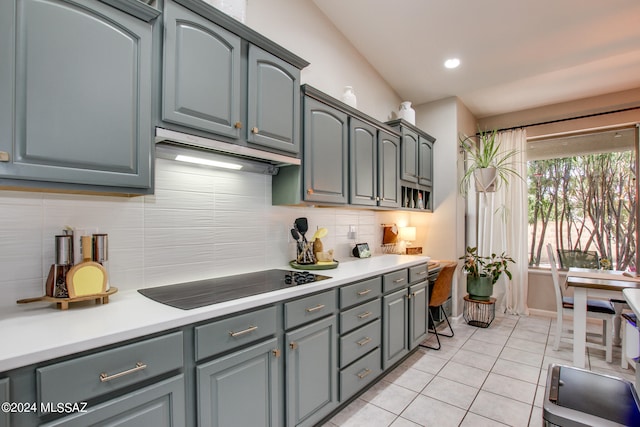 kitchen with gray cabinetry, tasteful backsplash, black electric cooktop, and light tile patterned floors