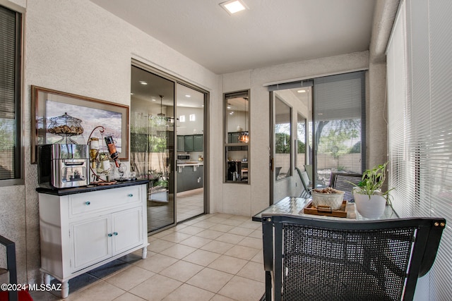 interior space with white cabinetry and light tile patterned floors